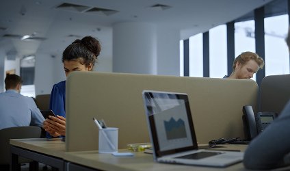 Laptop showing a growth chart in an office